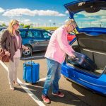 Travelers loading luggage into a car during a Puerto Vallarta airport transfer stop